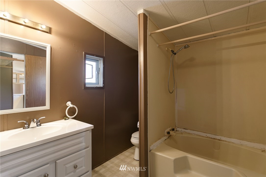 5998 Elder Road Ferndale, WA 98248 - Photo 13 of 23 a bathroom with a granite countertop sink a toilet and shower