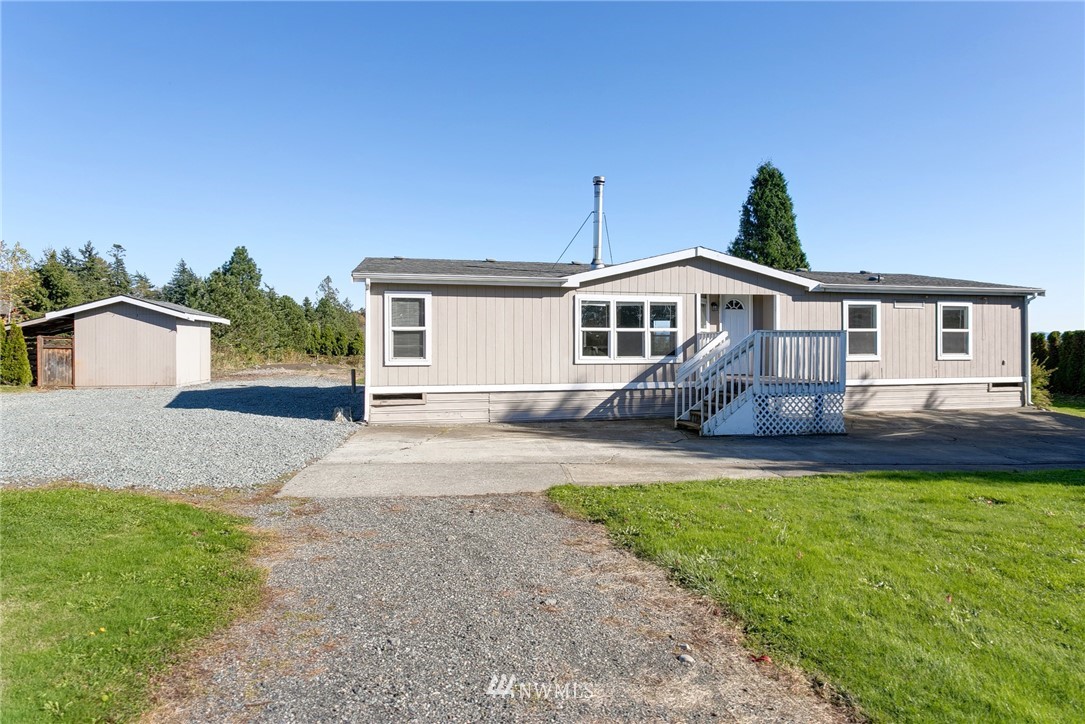 5998 Elder Road Ferndale, WA 98248 - Photo 23 of 23 a front view of a house with a garden and yard