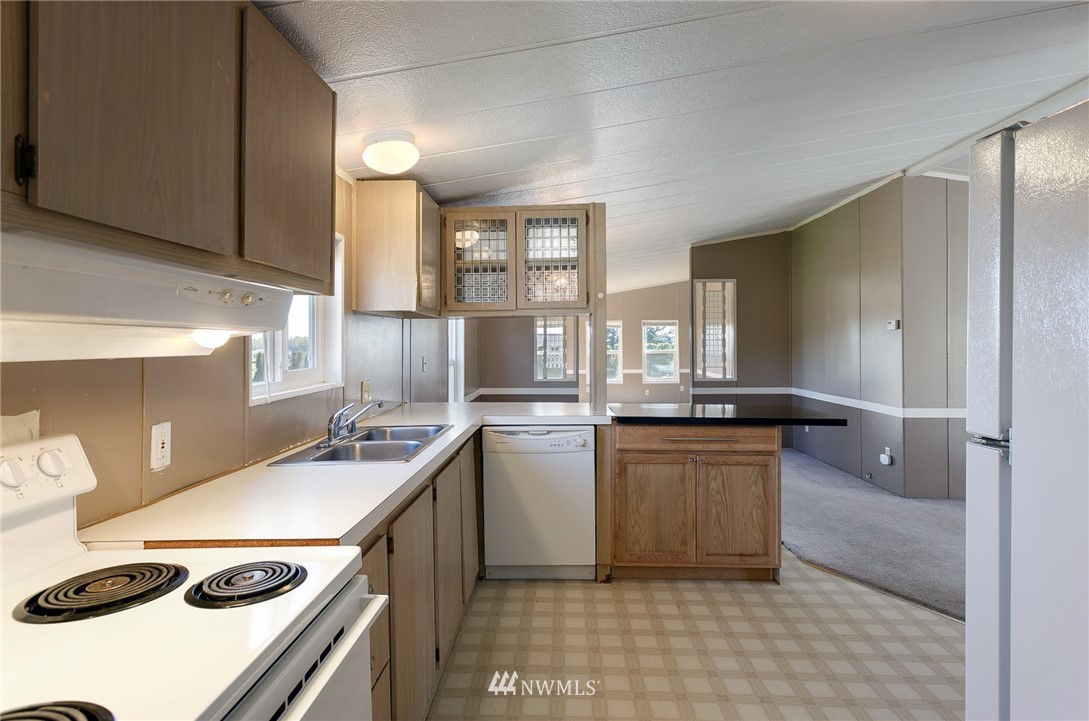 5998 Elder Road Ferndale, WA 98248 - Photo 6 of 23 a kitchen with a sink a stove and cabinets