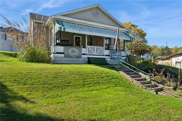 a view of a patio with table and chairs under an umbrella