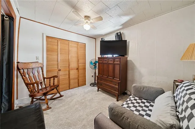a bedroom with furniture and a flat screen tv