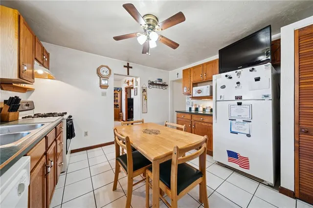a kitchen with stainless steel appliances a stove a refrigerator and a refrigerator