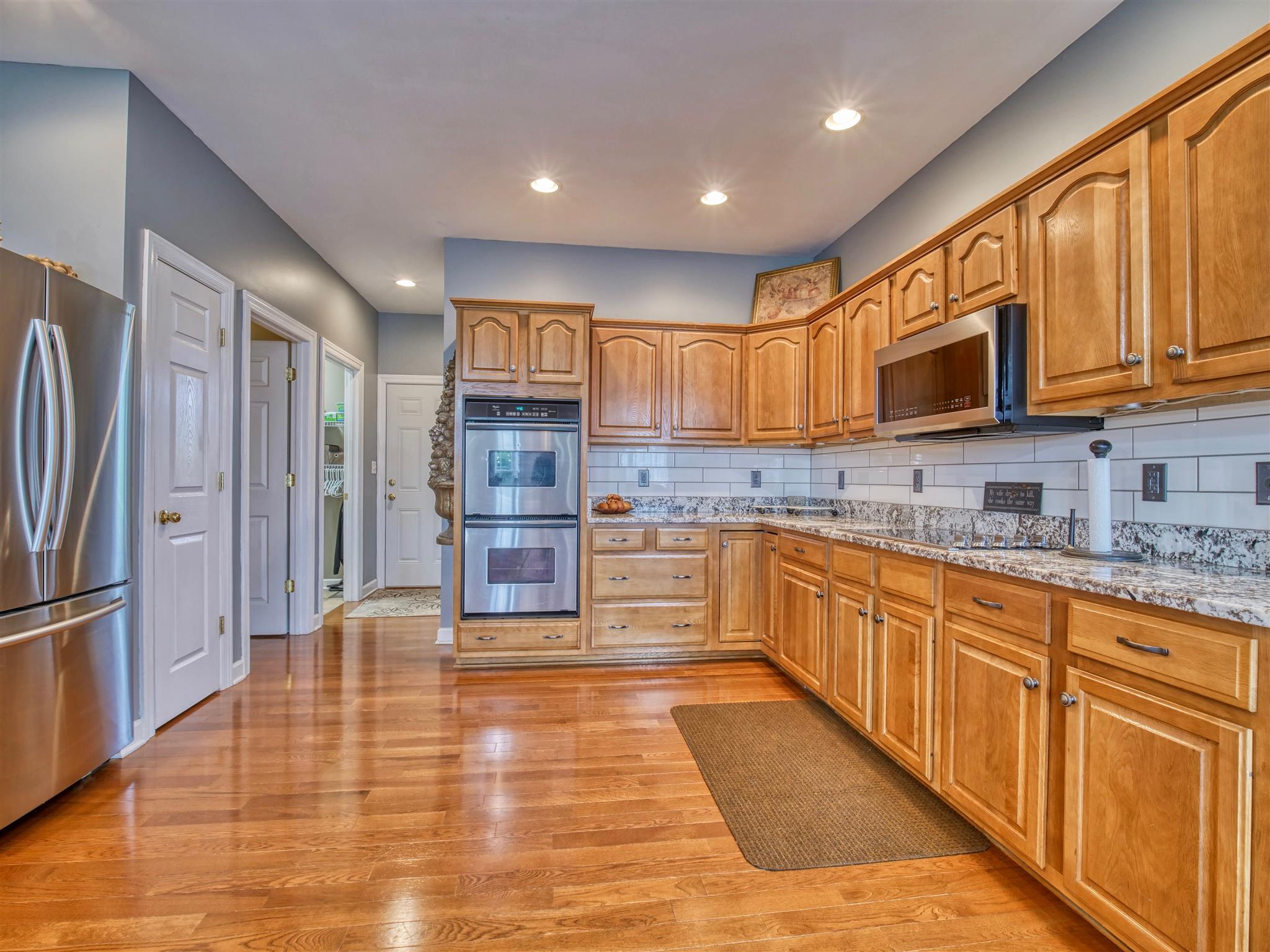1654 Berea Church Road Lebanon, TN 37087 - Photo 5 of 30 a kitchen with stainless steel appliances granite countertop a refrigerator and wooden cabinets