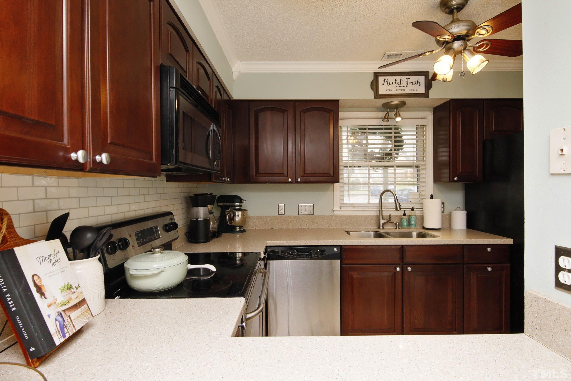 116 Long Shadow Place Durham, NC 27713 - Photo 11 of 38 a kitchen with a sink a stove and cabinets