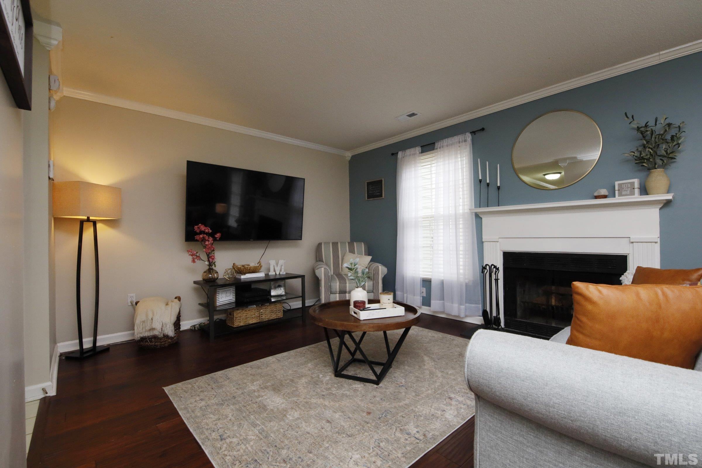 116 Long Shadow Place Durham, NC 27713 - Photo 16 of 38 a living room with furniture a fireplace and a flat screen tv
