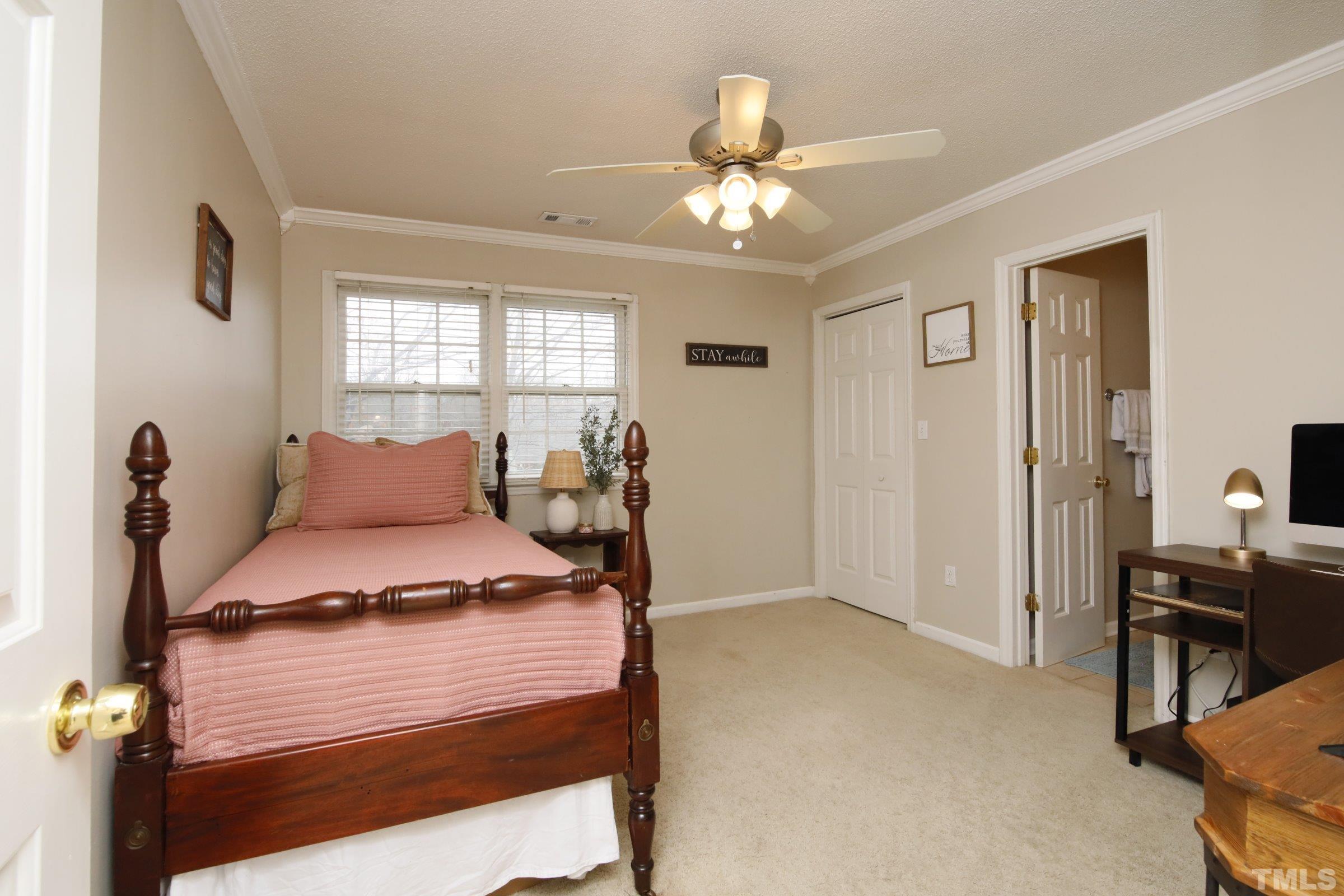 116 Long Shadow Place Durham, NC 27713 - Photo 28 of 38 a bedroom with a bed and a chandelier