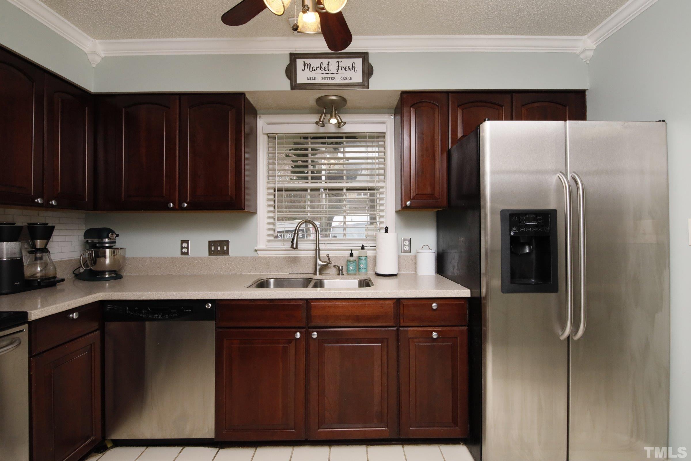 116 Long Shadow Place Durham, NC 27713 - Photo 8 of 38 a kitchen with stainless steel appliances granite countertop a sink stove and refrigerator