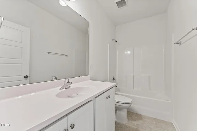 a view of an empty room with a window and closet