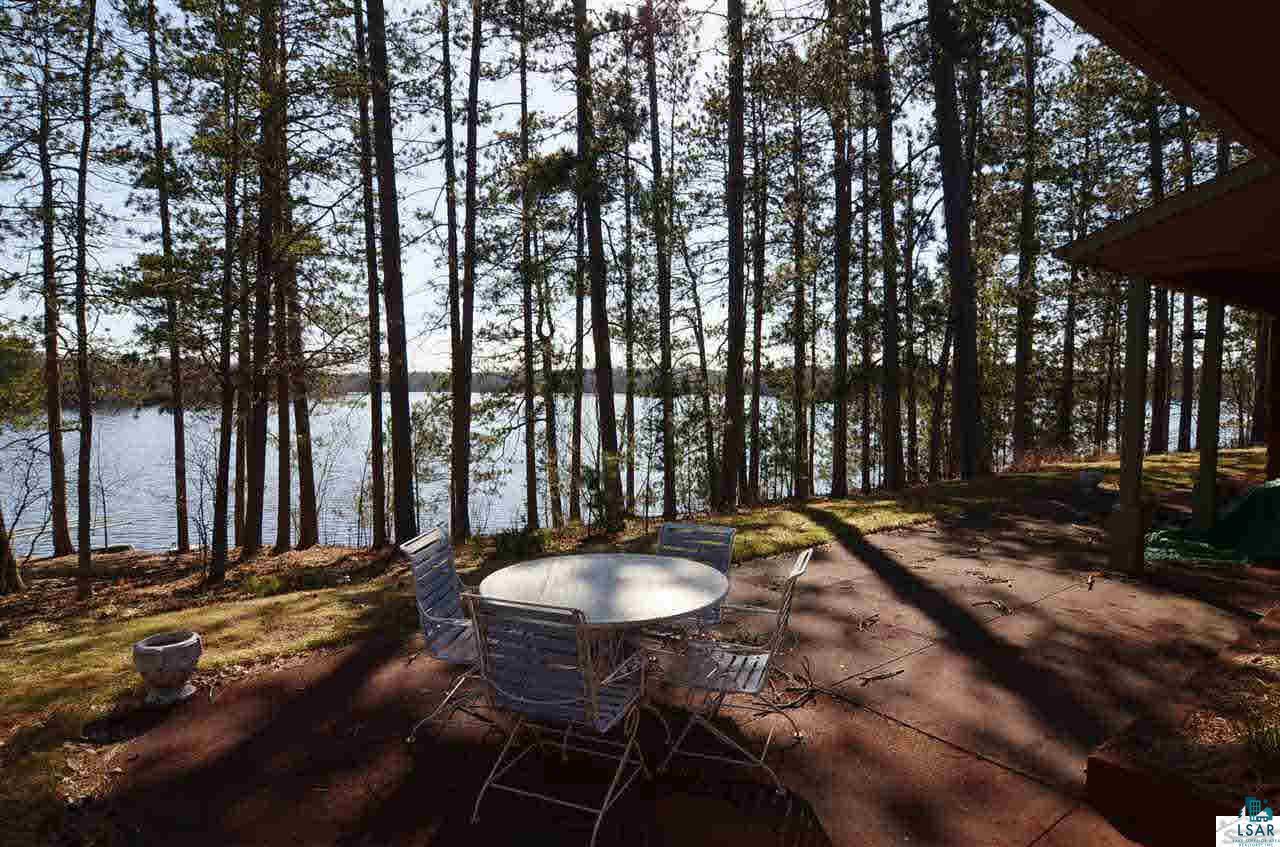 8175 County Rd P Lake Nebagamon, WI 54849 - Photo 3 of 25 Patio and grassy path with gradual slope to lake!