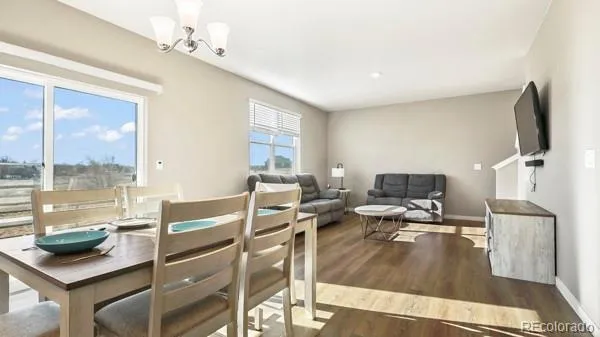 a living room with furniture a flat screen tv and a floor to ceiling window