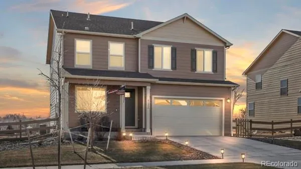 a front view of a house with glass windows and table