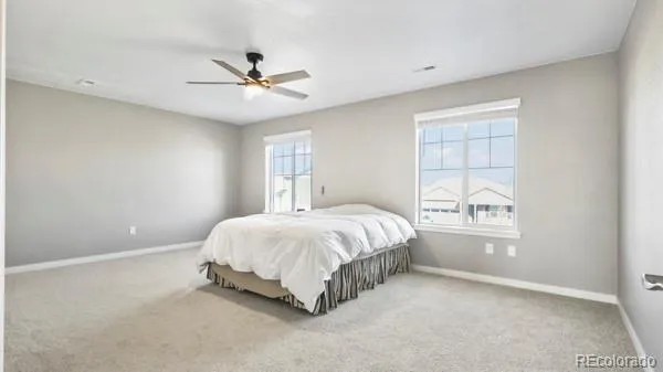 a spacious bedroom with a bed and a window