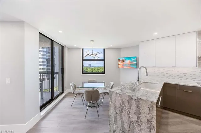 a kitchen with stainless steel appliances kitchen island granite countertop a sink and cabinets