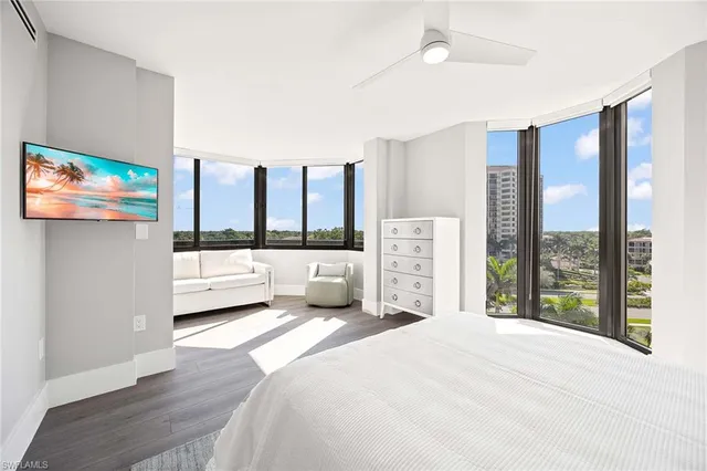 a bedroom with a large bed and a large window