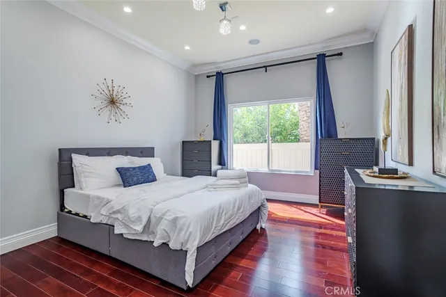 a bedroom with a large bed and a chandelier