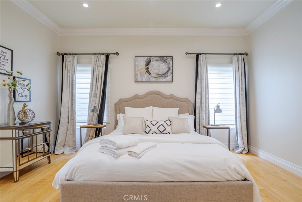 12945 Calvert Street Van Nuys, CA 91401 - Photo 17 of 57 a bedroom with a large bed and a window