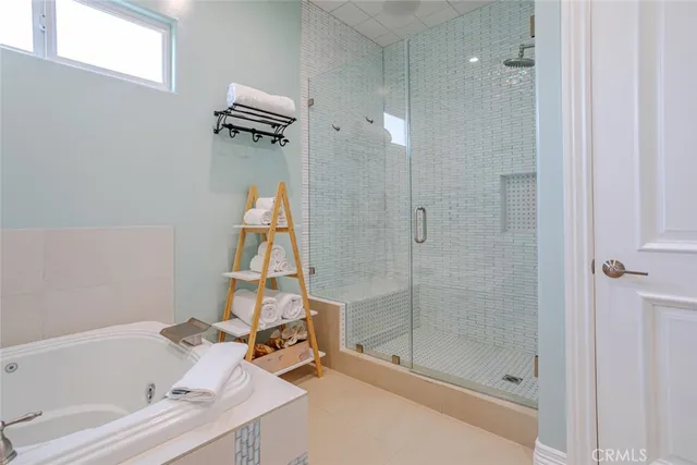 a bathroom with a granite countertop mirror a toilet and a shower