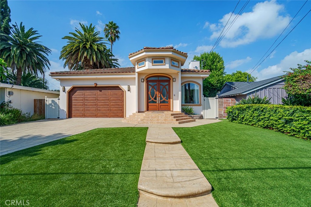 12945 Calvert Street Van Nuys, CA 91401 - Photo 2 of 57 a front view of a house with a yard