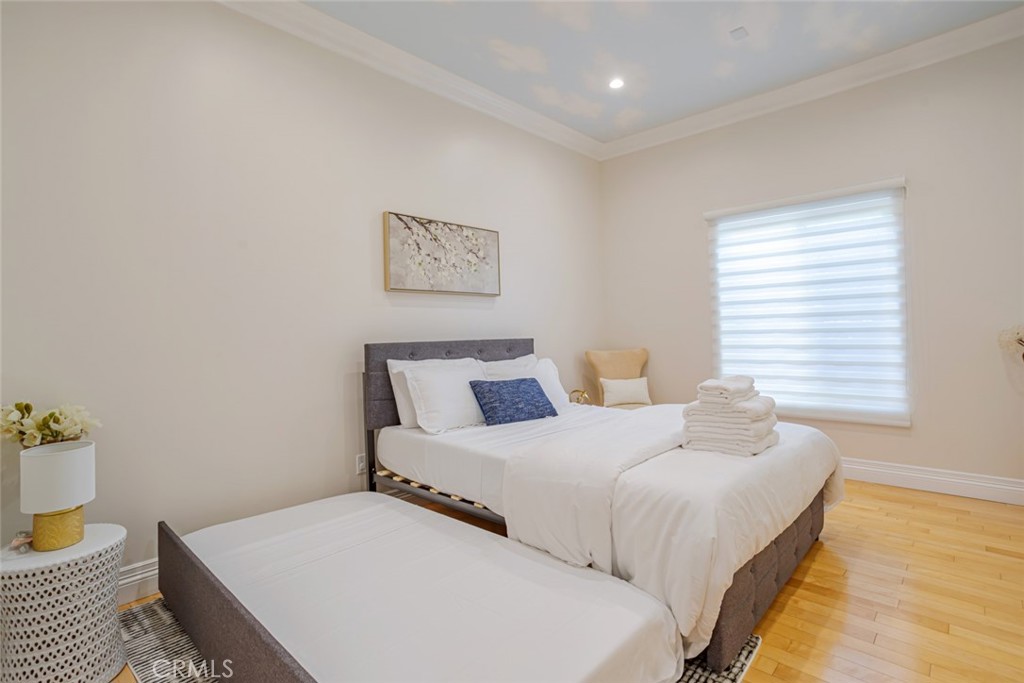 12945 Calvert Street Van Nuys, CA 91401 - Photo 22 of 57 a bedroom with bed and wooden floor