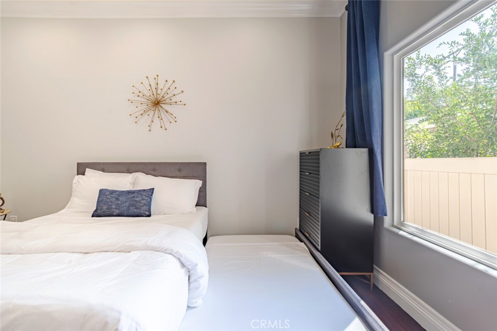 12945 Calvert Street Van Nuys, CA 91401 - Photo 23 of 57 a bedroom with a large bed and a window