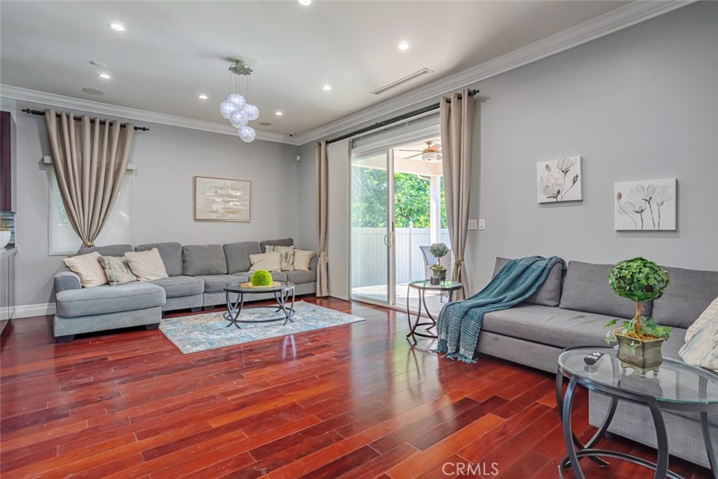 12945 Calvert Street Van Nuys, CA 91401 - Photo 25 of 57 a living room with furniture and a wooden floor