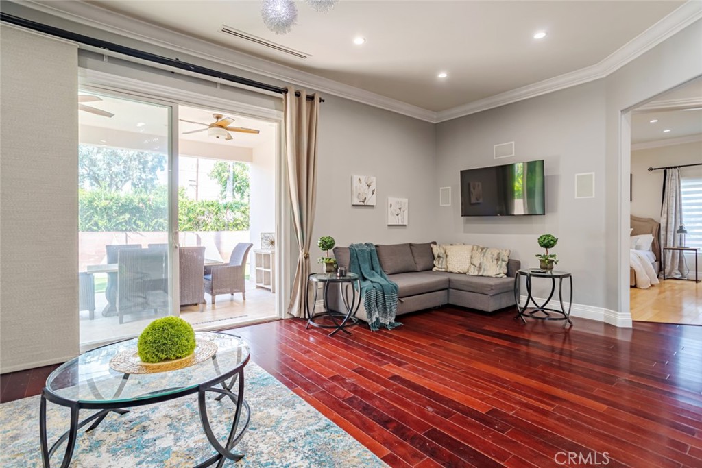 12945 Calvert Street Van Nuys, CA 91401 - Photo 27 of 57 a living room with furniture and a wooden floor