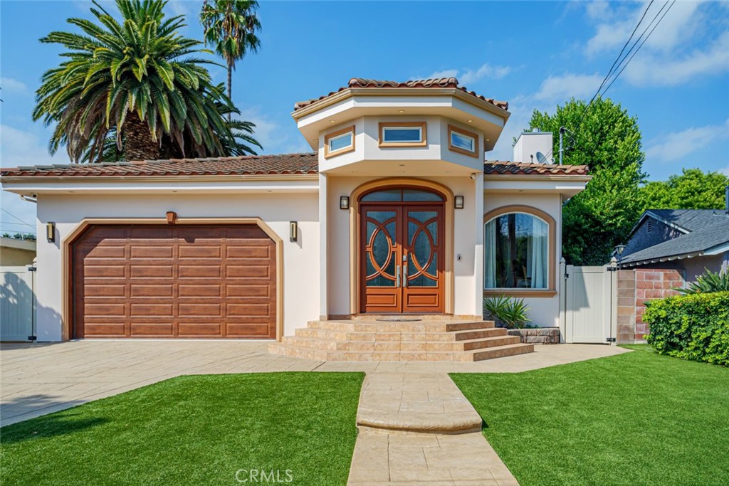 12945 Calvert Street Van Nuys, CA 91401 - Photo 3 of 57 a front view of a house with garden