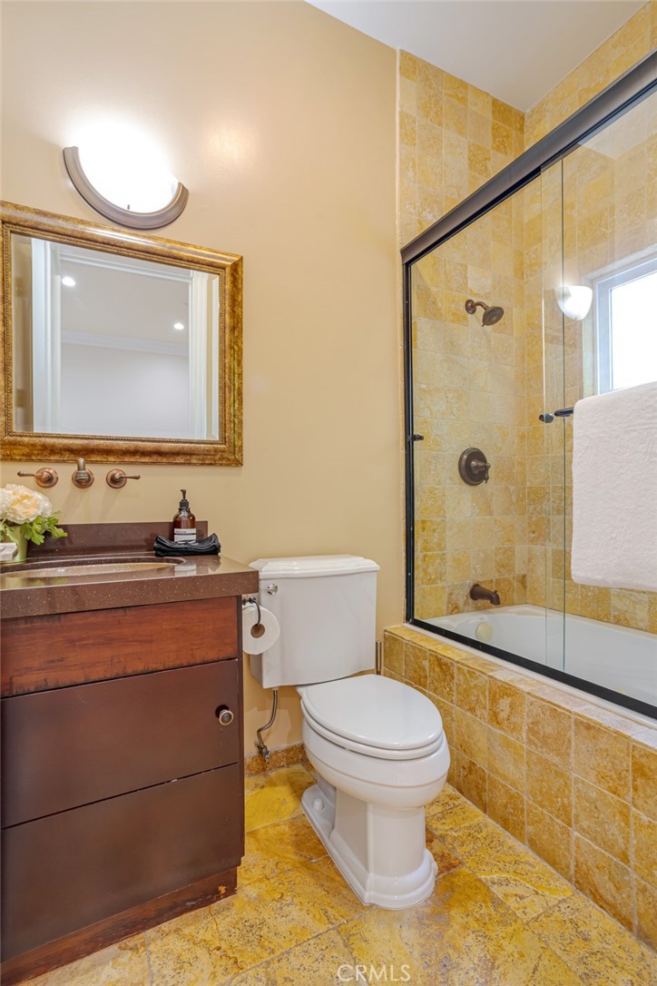 12945 Calvert Street Van Nuys, CA 91401 - Photo 34 of 57 a bathroom with a sink a toilet and shower