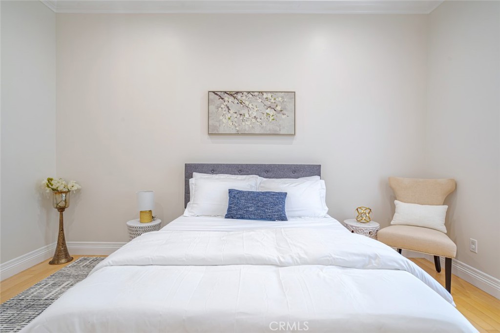 12945 Calvert Street Van Nuys, CA 91401 - Photo 36 of 57 a bedroom with a bed and chair