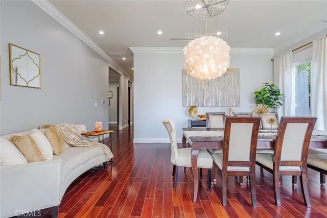a view of a a dining room with furniture window and wooden floor