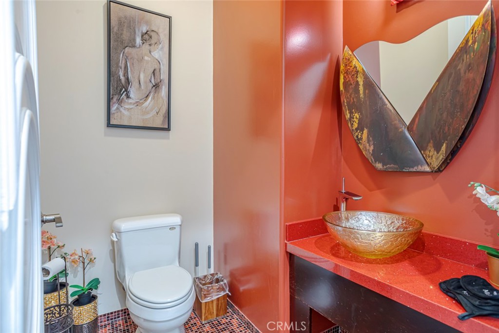 12945 Calvert Street Van Nuys, CA 91401 - Photo 42 of 57 a bathroom with a toilet a sink and a mirror