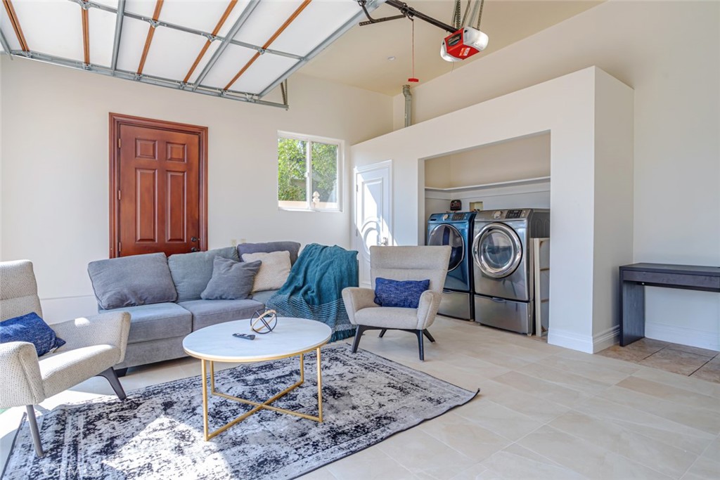12945 Calvert Street Van Nuys, CA 91401 - Photo 47 of 57 a living room with furniture a rug and a fireplace