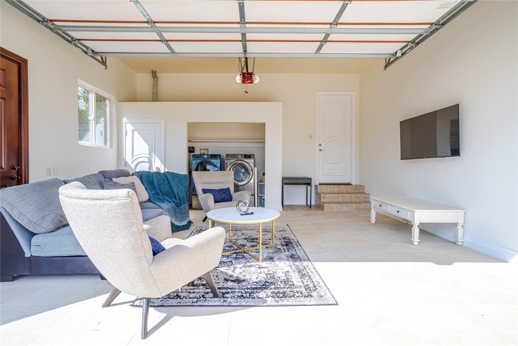 12945 Calvert Street Van Nuys, CA 91401 - Photo 53 of 57 a living room with a couch and a flat screen tv