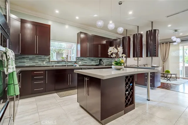 a kitchen with stainless steel appliances granite countertop a sink a stove and a refrigerator