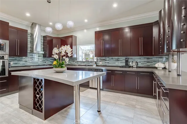 a kitchen with kitchen island granite countertop a sink and white cabinets