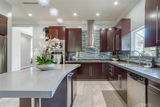a kitchen with a refrigerator a sink and wooden cabinets