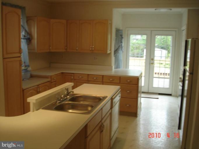 420 Walcott Road Baltimore, MD 21206 - Photo 6 of 11 a kitchen that has a sink and a stove