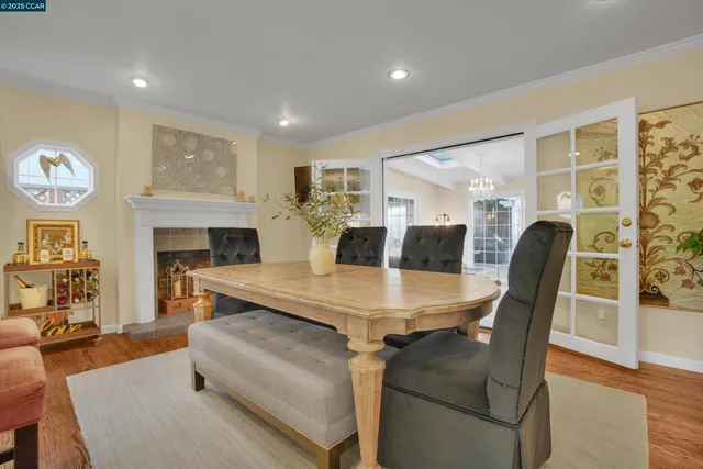 a dining table with fireplace and wooden floor