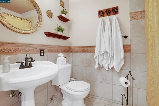 a bathroom with a sink a toilet and a mirror