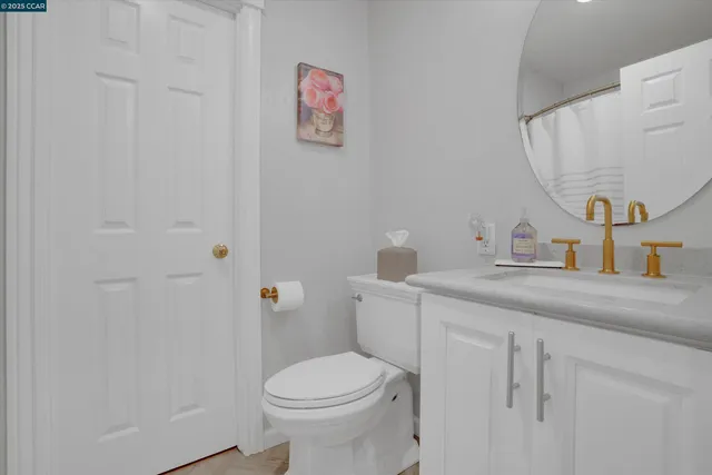 a bathroom with a sink a toilet and mirror