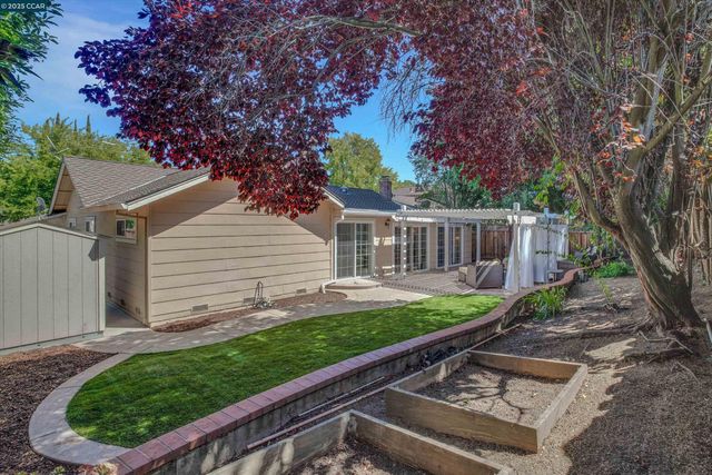 a view of backyard with a garden and deck