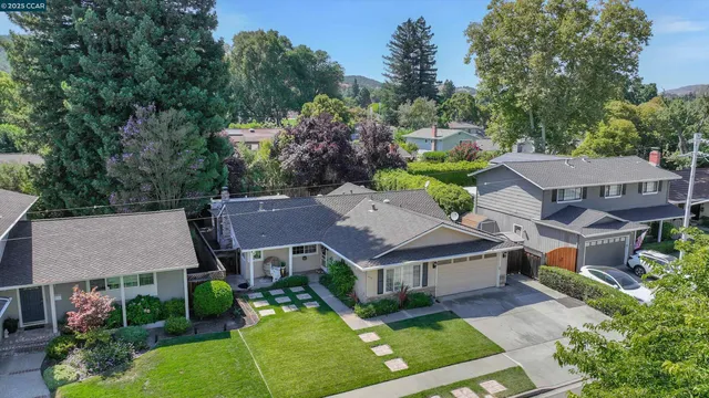 an aerial view of multiple houses with yard