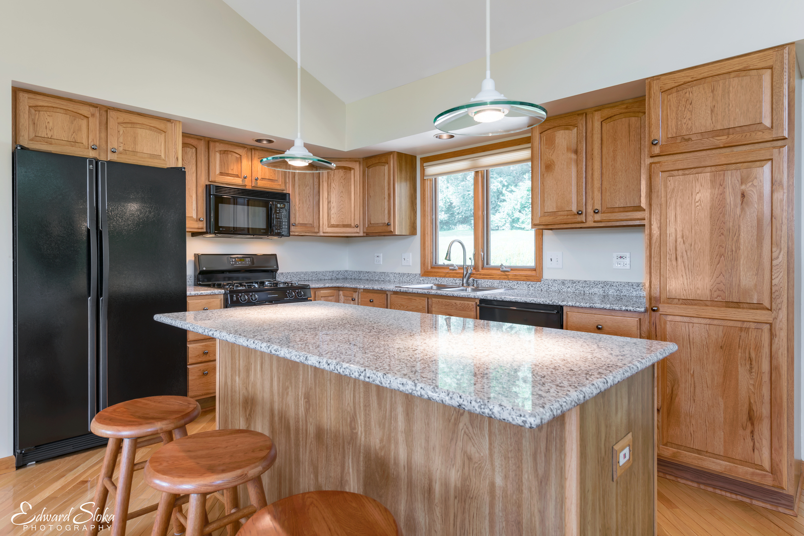 288 Fox Harbor Road Trout Valley, IL 60013 - Photo 8 of 34 a kitchen with stainless steel appliances granite countertop a sink a microwave a refrigerator and wooden cabinets