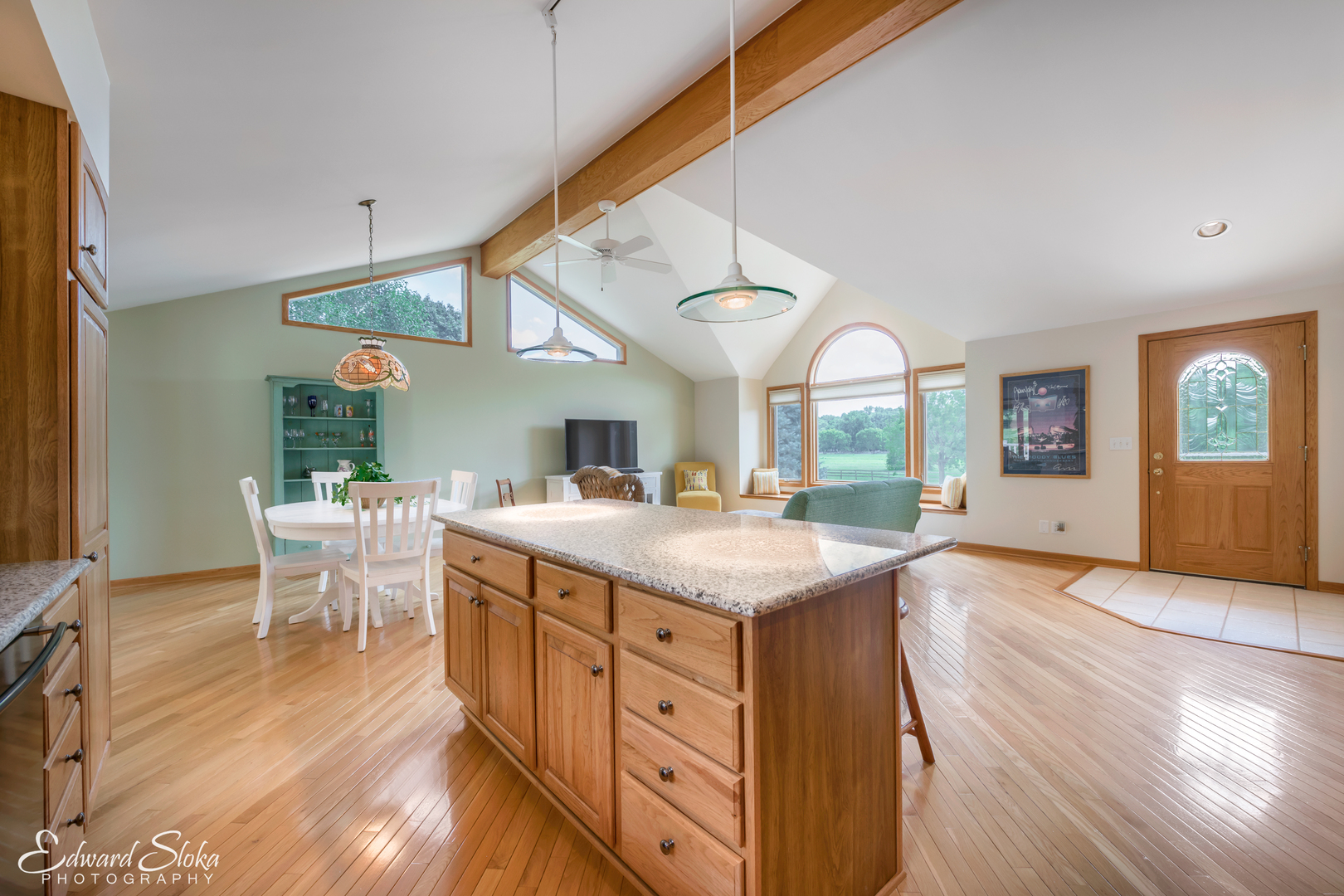 288 Fox Harbor Road Trout Valley, IL 60013 - Photo 10 of 34 a kitchen with a stove a sink a dining table and chairs with wooden floor