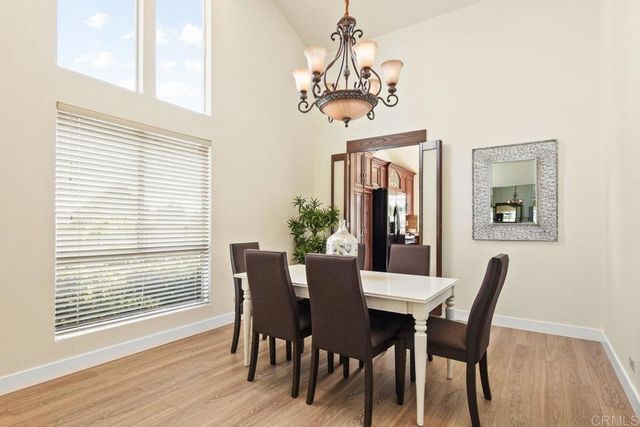 a view of a dining room with furniture wooden floor and a chandelier