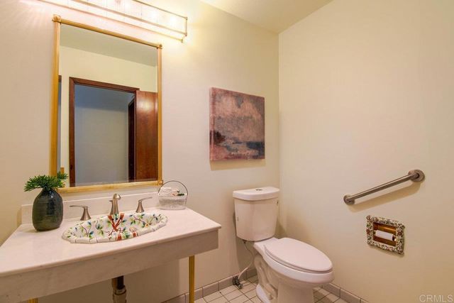 a kitchen with a sink a stove cabinets and wooden floor