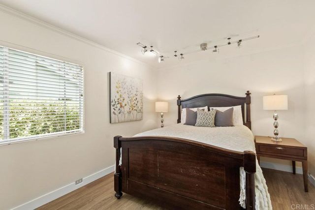 a bedroom with a bed and a table chair