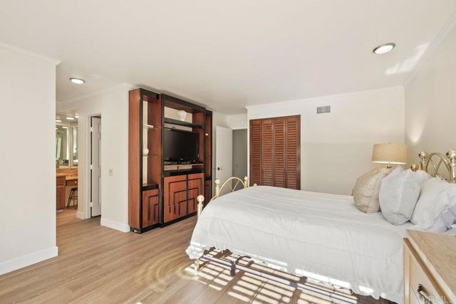 a bathroom with a granite countertop sink a mirror and a shower
