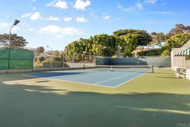 a hallway with a couch and a potted plant