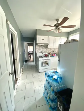 a bed room with a bed and a ceiling fan